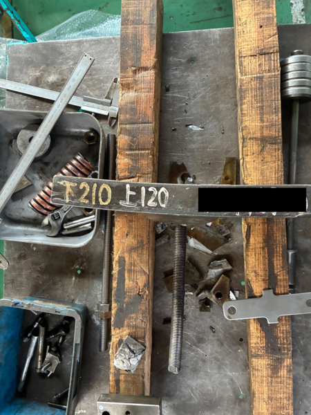 プレス金型のダイホルダーが異常荷重により弧を描くように大きく歪んでいる様子